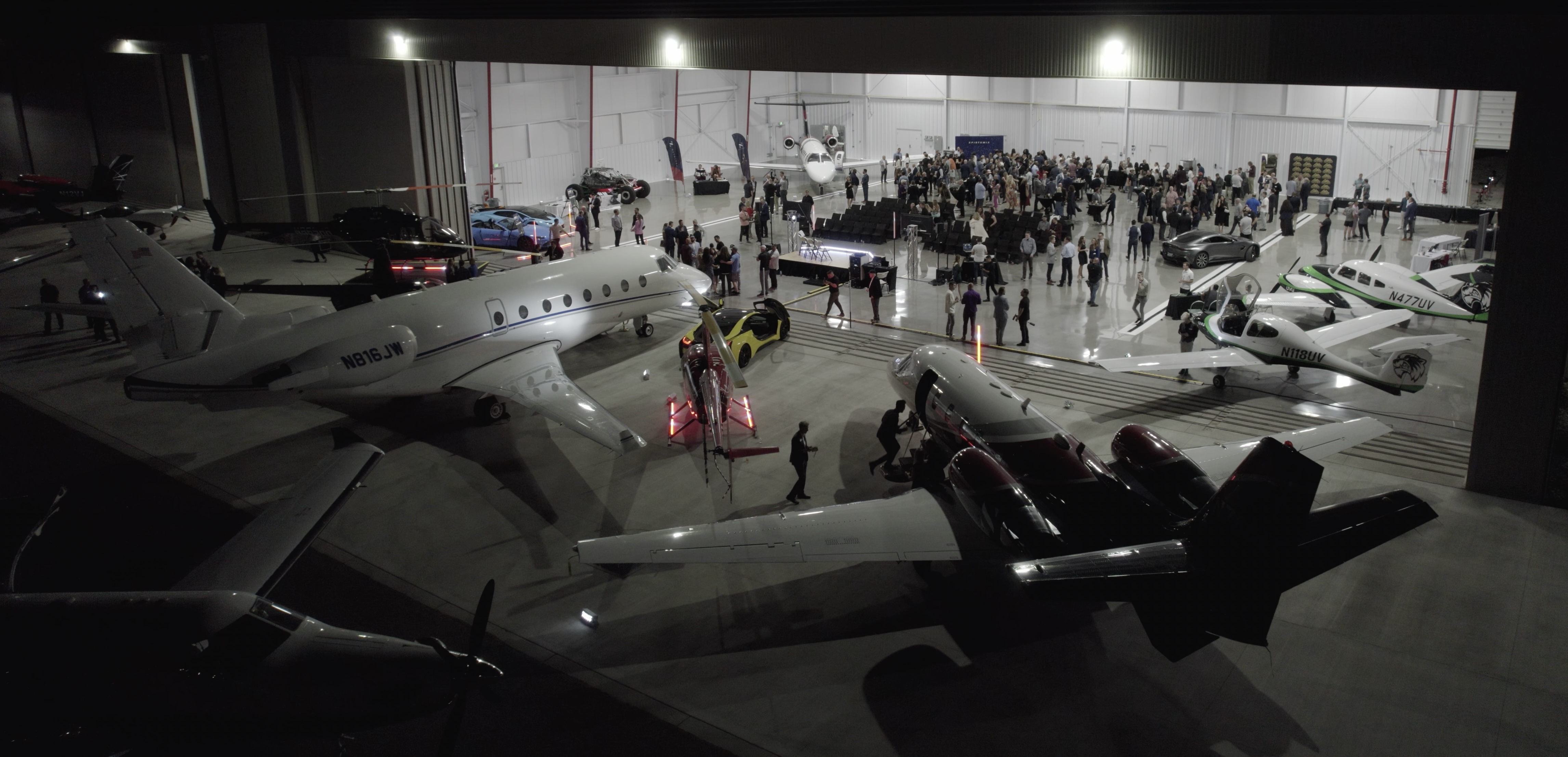 Aircraft in a hangar at night during an aviation event